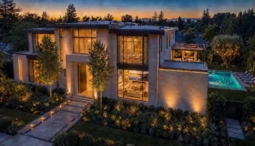 Concept visualization of a warm modern foyer opening into a luxury home at dusk